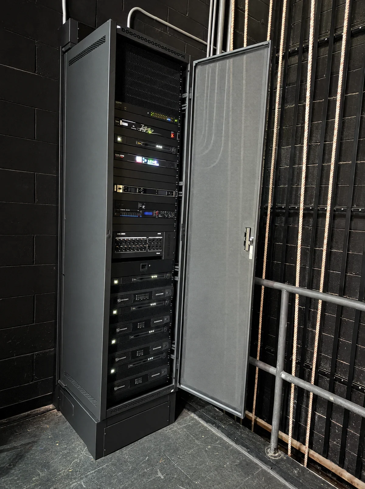 User-supplied photo of a commercial low-voltage equipment rack with its door open