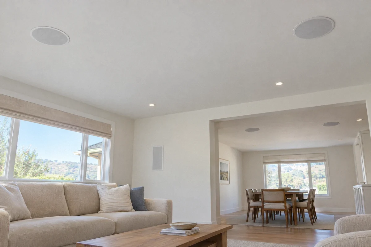 Illustration of flush ceiling and in-wall speakers serving adjoining rooms